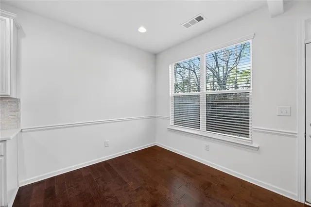a view of a hallway with paintings on the wall