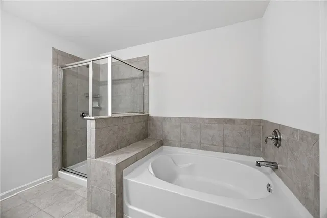 a bathroom with a granite countertop sink a toilet a mirror a bathtub and shower