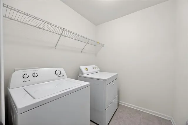 a view of a house with a small yard and wooden floor and fence