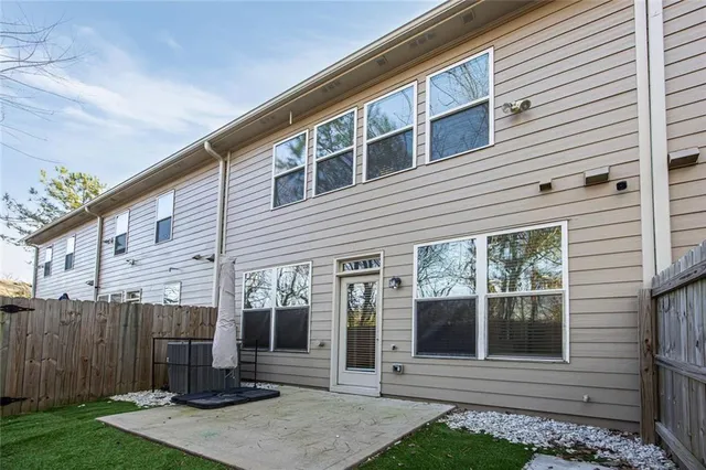 a view of a backyard with wooden fence