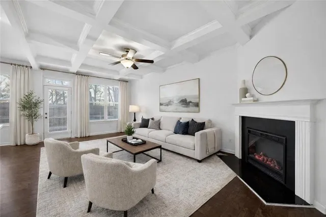 an empty room with wooden floor fireplace and windows
