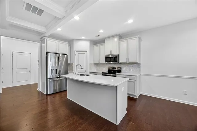 a kitchen with stainless steel appliances a refrigerator stove microwave and sink