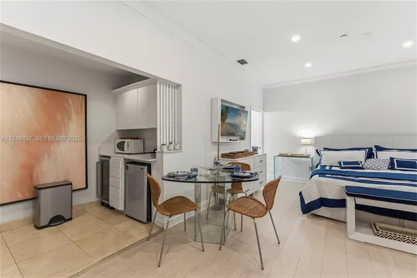 a kitchen that has a table and chairs in it