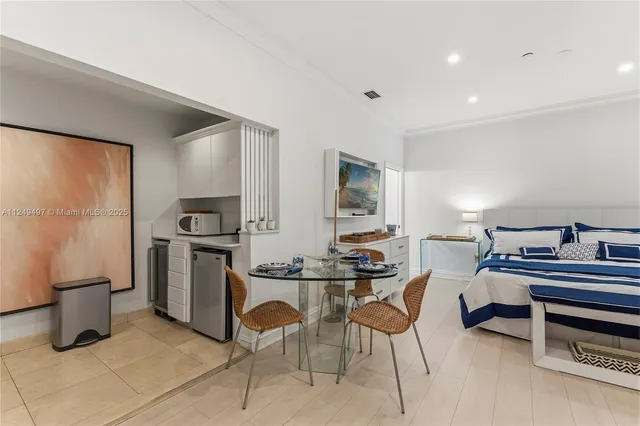a kitchen that has a table and chairs in it