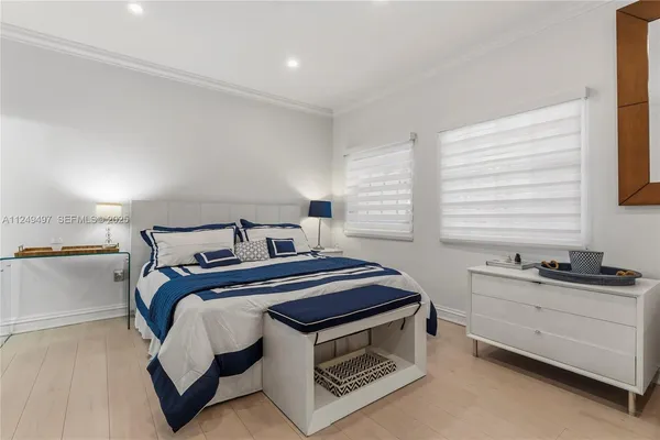 a bed sitting in a room next to a window