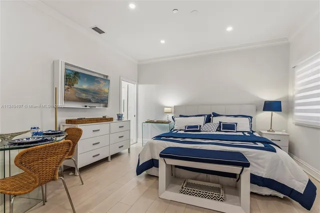 a bedroom with furniture and a window