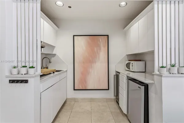 a kitchen with a refrigerator stove and sink