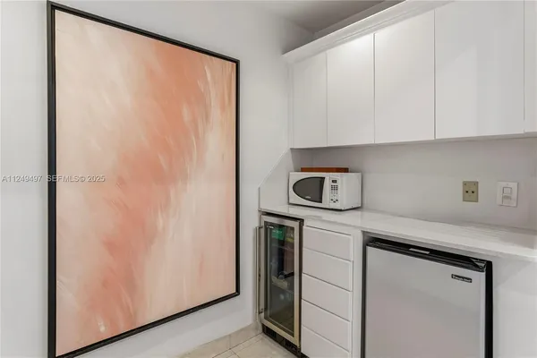 a living room with furniture and a painting on the wall