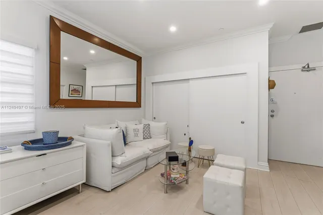 a living room with furniture and a painting on the wall