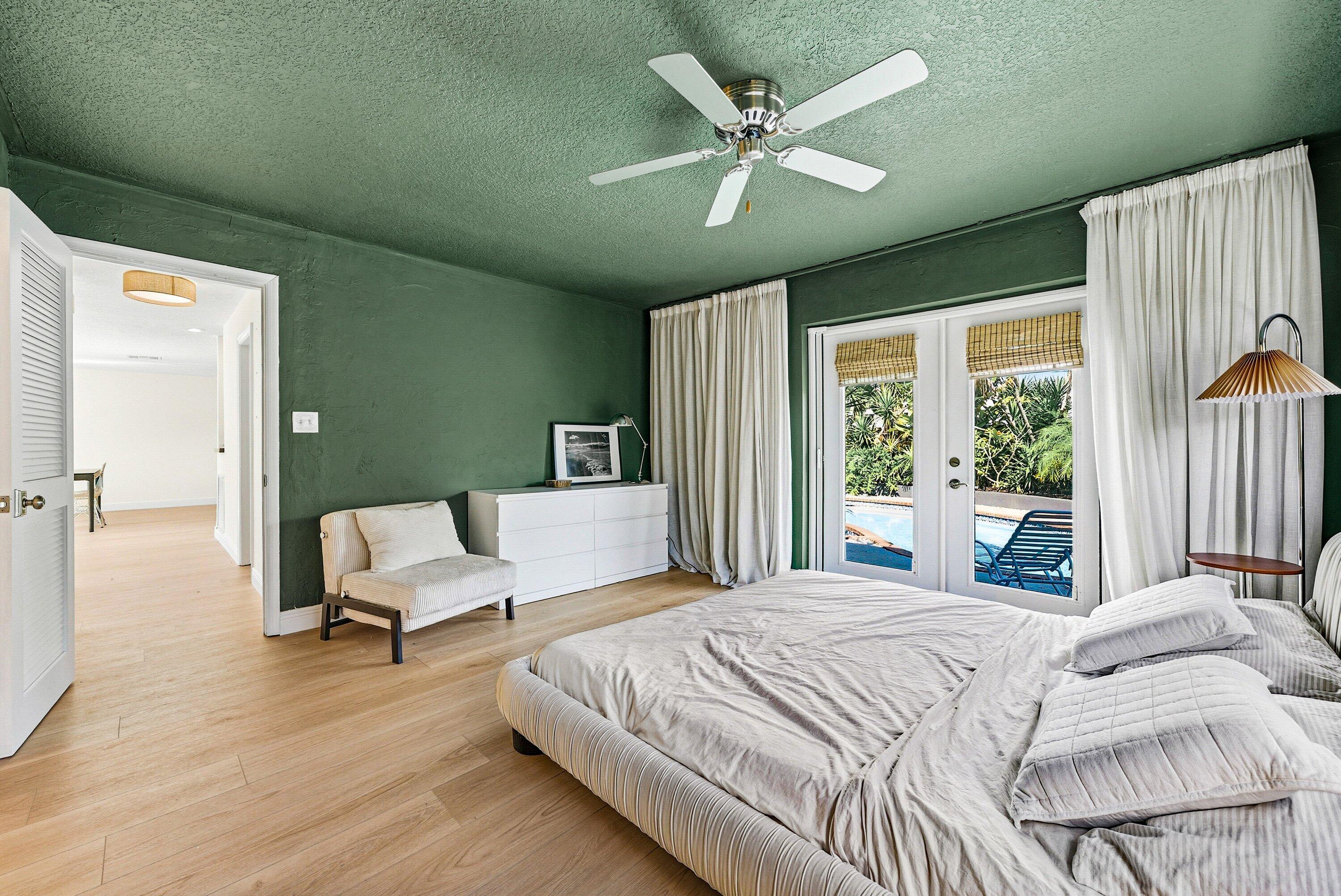 435 Northeast 35th Street Boca Raton, FL 33431 - Photo 24 of 62 a bedroom with a large bed and a large window