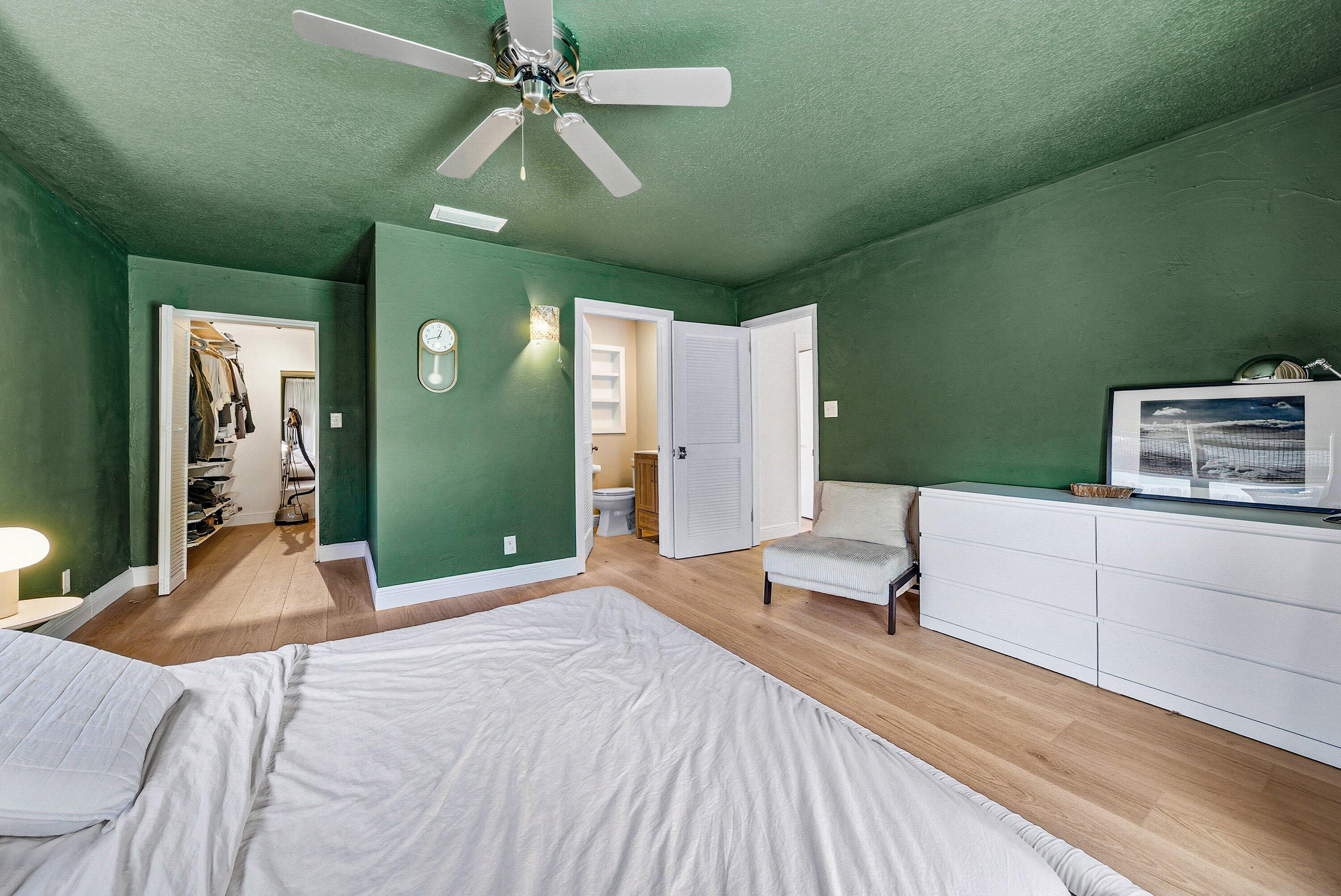 435 Northeast 35th Street Boca Raton, FL 33431 - Photo 25 of 62 a bedroom with a bed and a chandelier