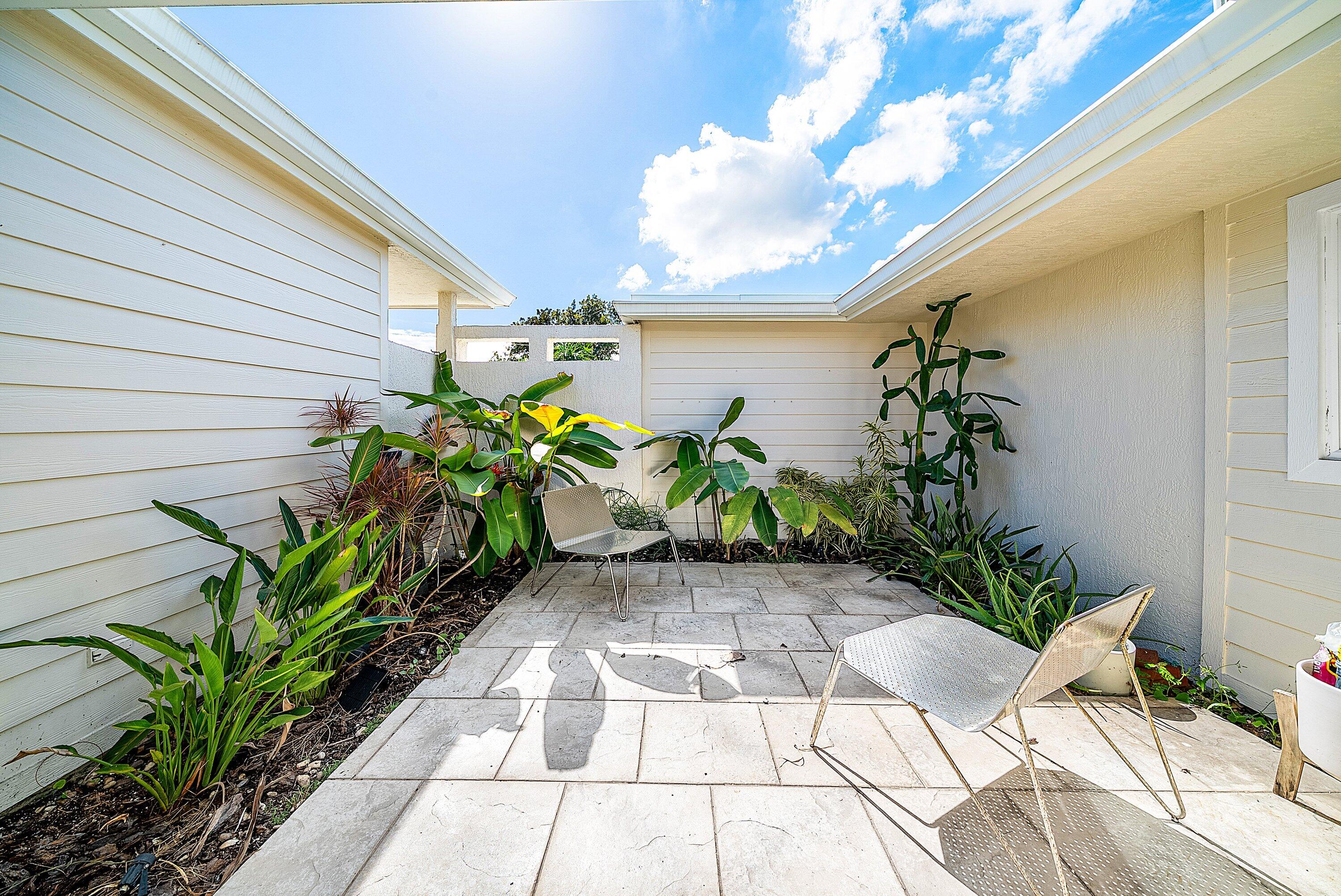 435 Northeast 35th Street Boca Raton, FL 33431 - Photo 32 of 62 a view of a entryway with flower pots