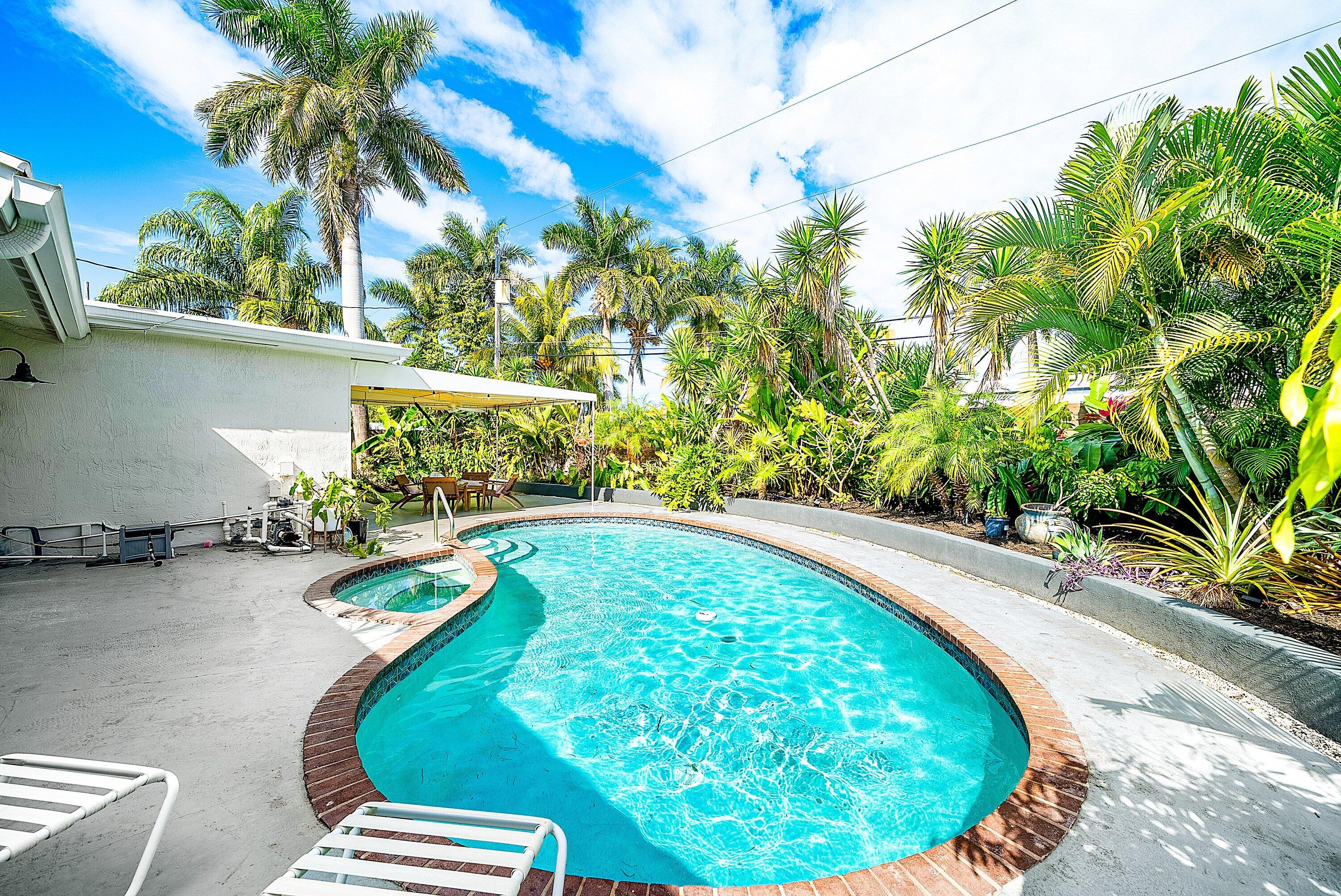 435 Northeast 35th Street Boca Raton, FL 33431 - Photo 37 of 62 a view of a swimming pool with a yard