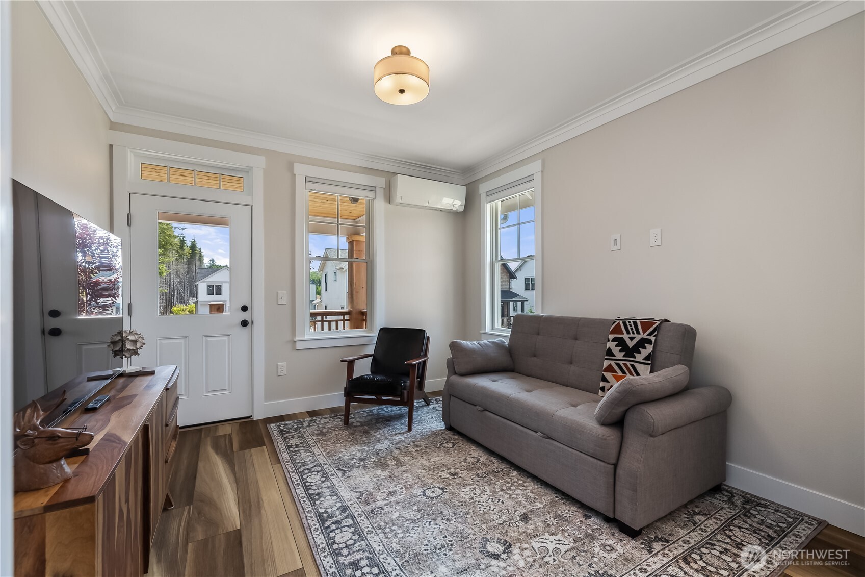 24 Switchback Lane Pacific Beach, WA 98571 - Photo 6 of 20 a living room with furniture a flat screen tv and a refrigerator