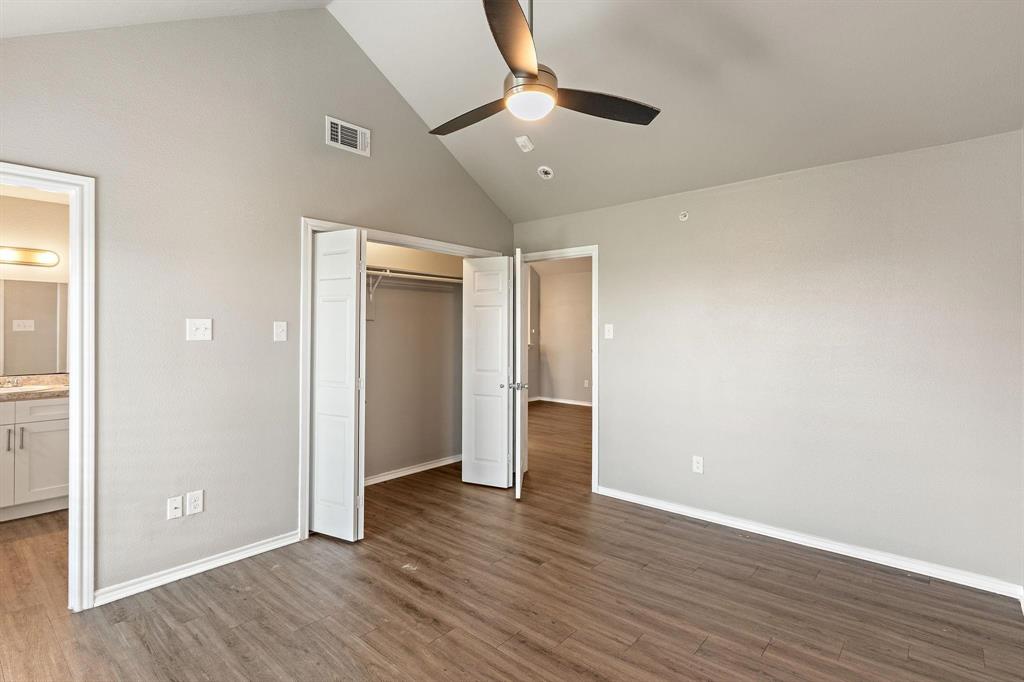 6108 Abrams Road, Unit 521 Dallas, TX 75231 - Photo 6 of 20 Spacious room featuring wood-finish flooring, vaulted ceiling, and a ceiling fan with integrated lighting