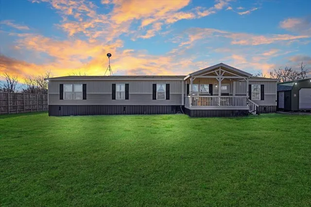 a view of a house with a big yard with a fountain and a yard