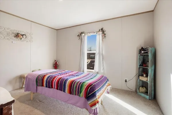 a bed sitting in a bedroom next to a window with dresser