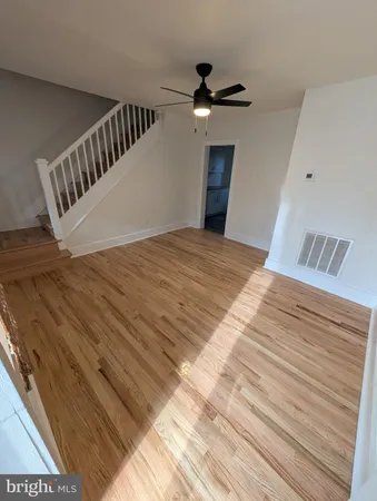 a view of a bedroom with wooden floor