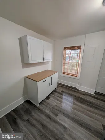 a living room with hard wood floors and a window