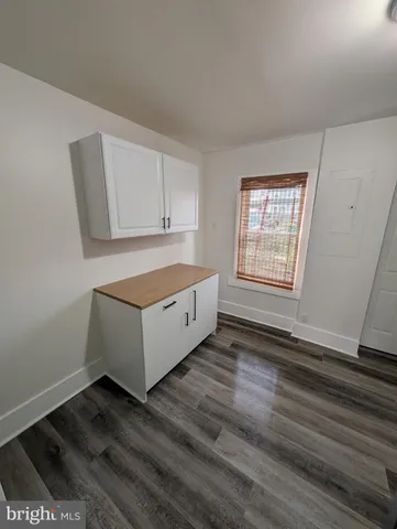 a living room with hard wood floors and a window