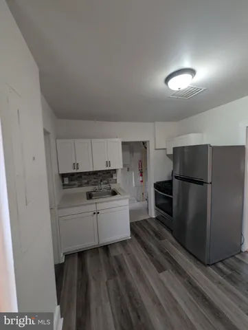 a kitchen with a refrigerator and a stove