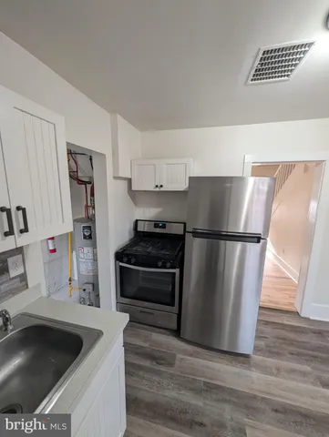 a kitchen with stainless steel appliances granite countertop a refrigerator stove and sink