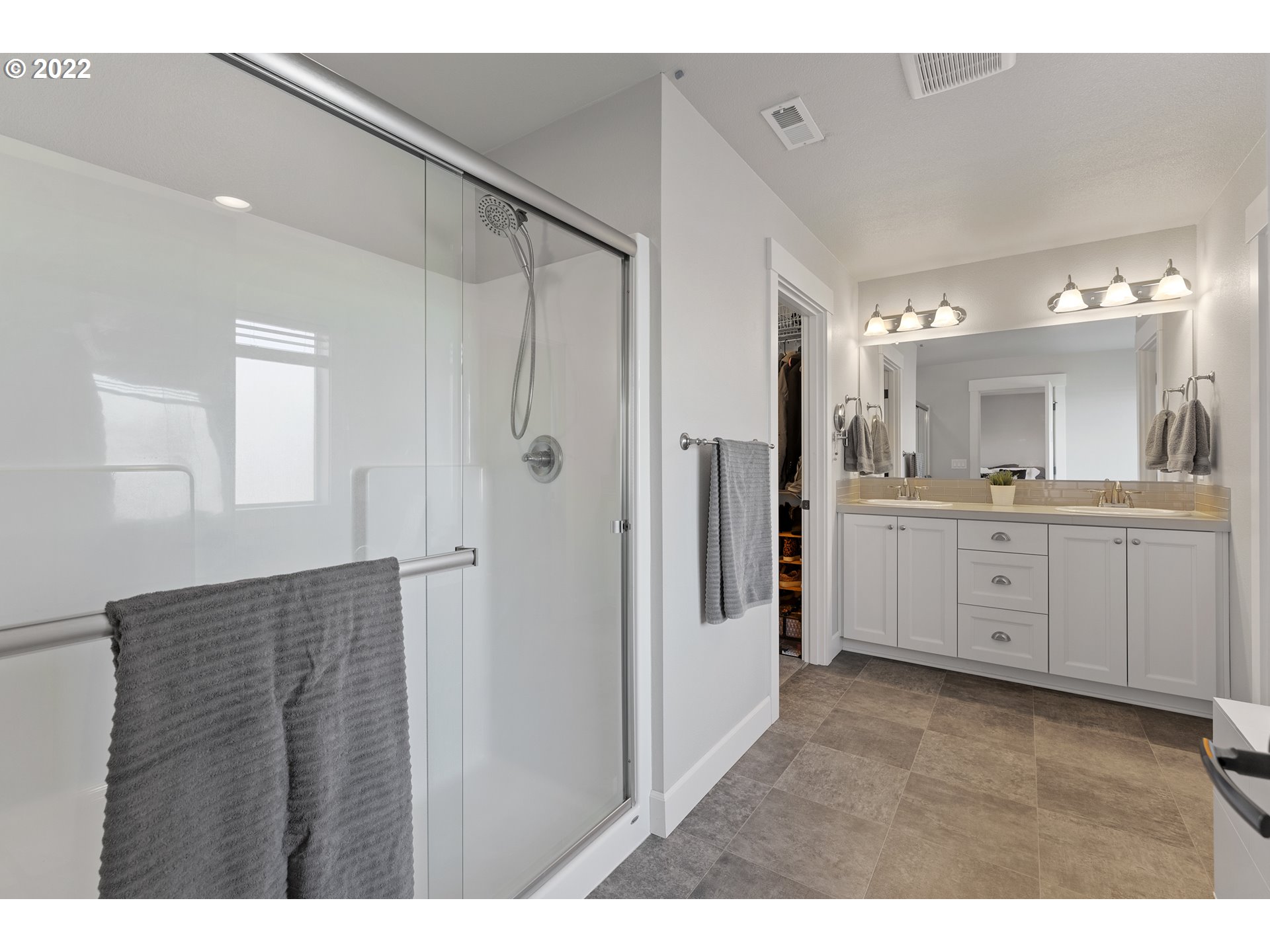 1146 South Quail Run Place Ridgefield, WA 98642 - Photo 21 of 32 a bathroom with a double vanity sink mirror and shower