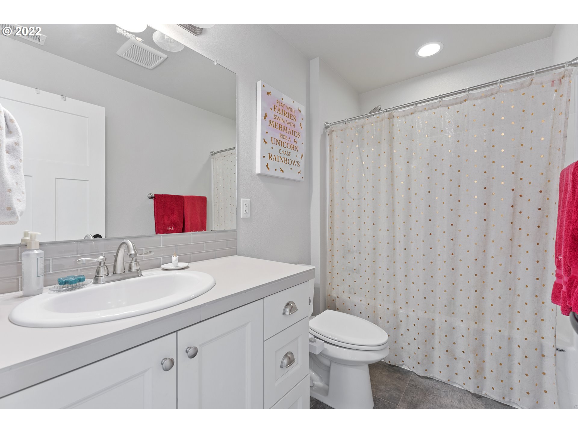 1146 South Quail Run Place Ridgefield, WA 98642 - Photo 29 of 32 a bathroom with a toilet a sink and a mirror