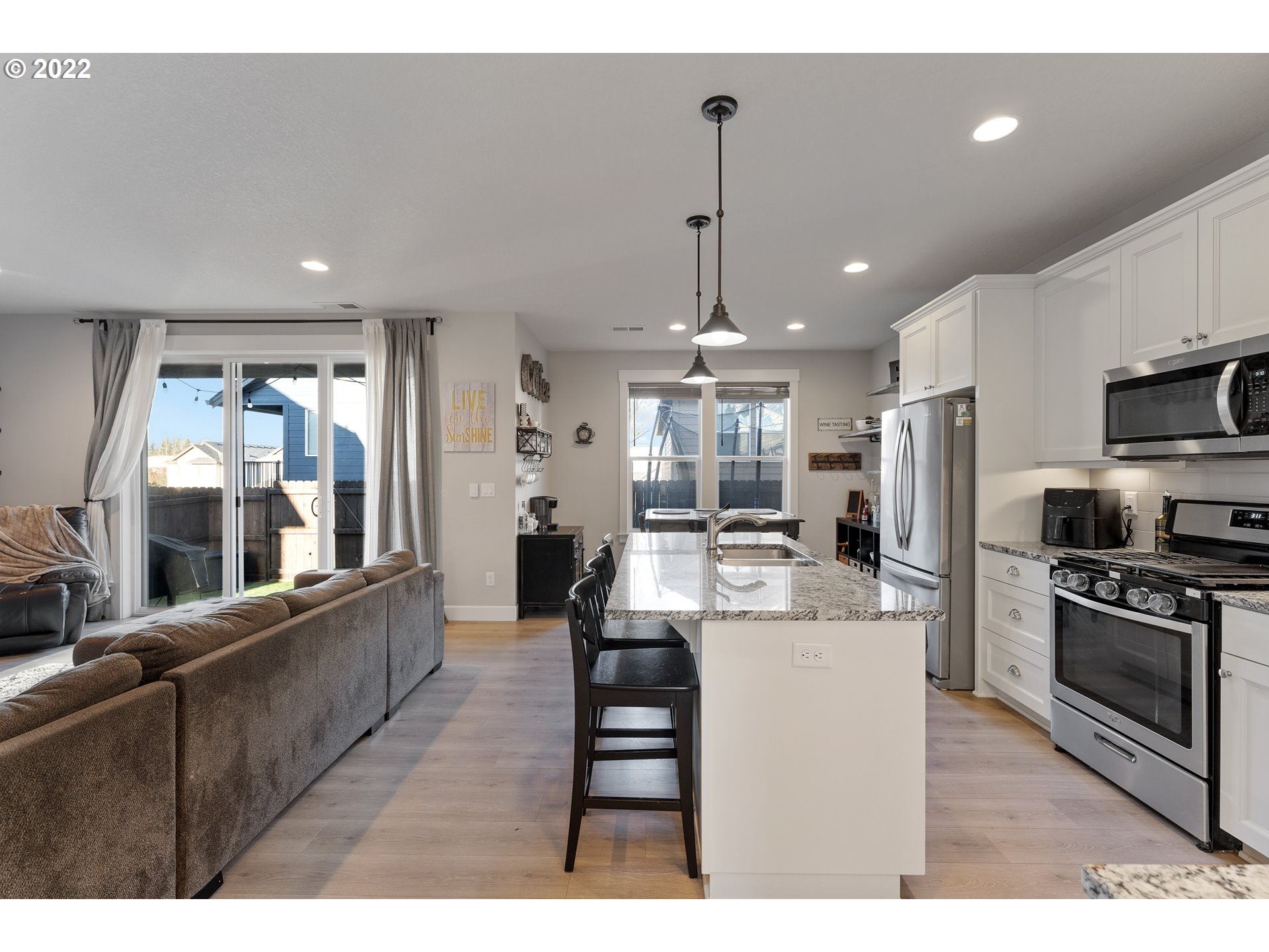 1146 South Quail Run Place Ridgefield, WA 98642 - Photo 3 of 32 a large kitchen with stainless steel appliances kitchen island granite countertop a large kitchen island a stove a refrigerator a sink and a view of living room