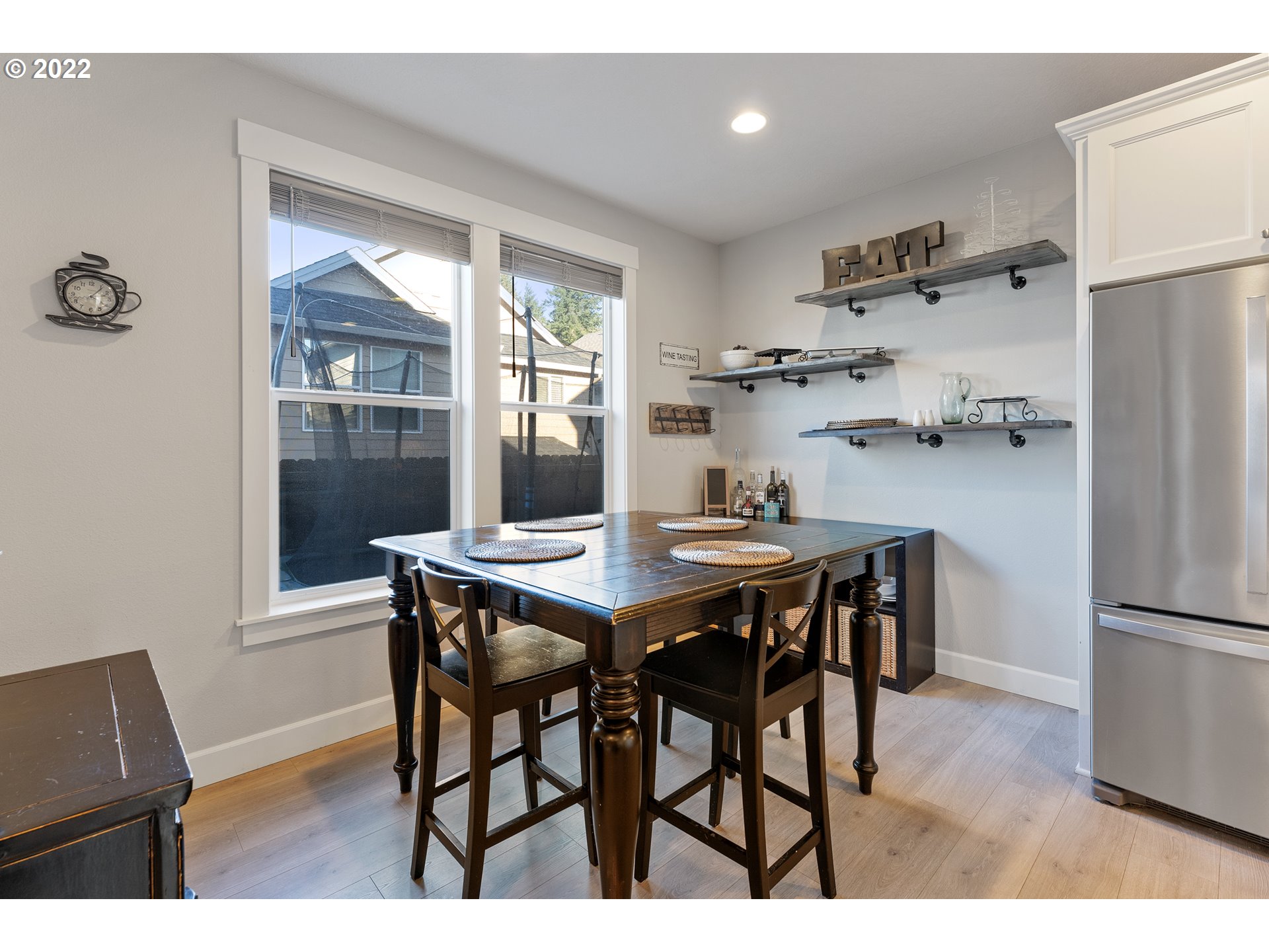 1146 South Quail Run Place Ridgefield, WA 98642 - Photo 10 of 32 a view of a dining room with furniture window and wooden floor