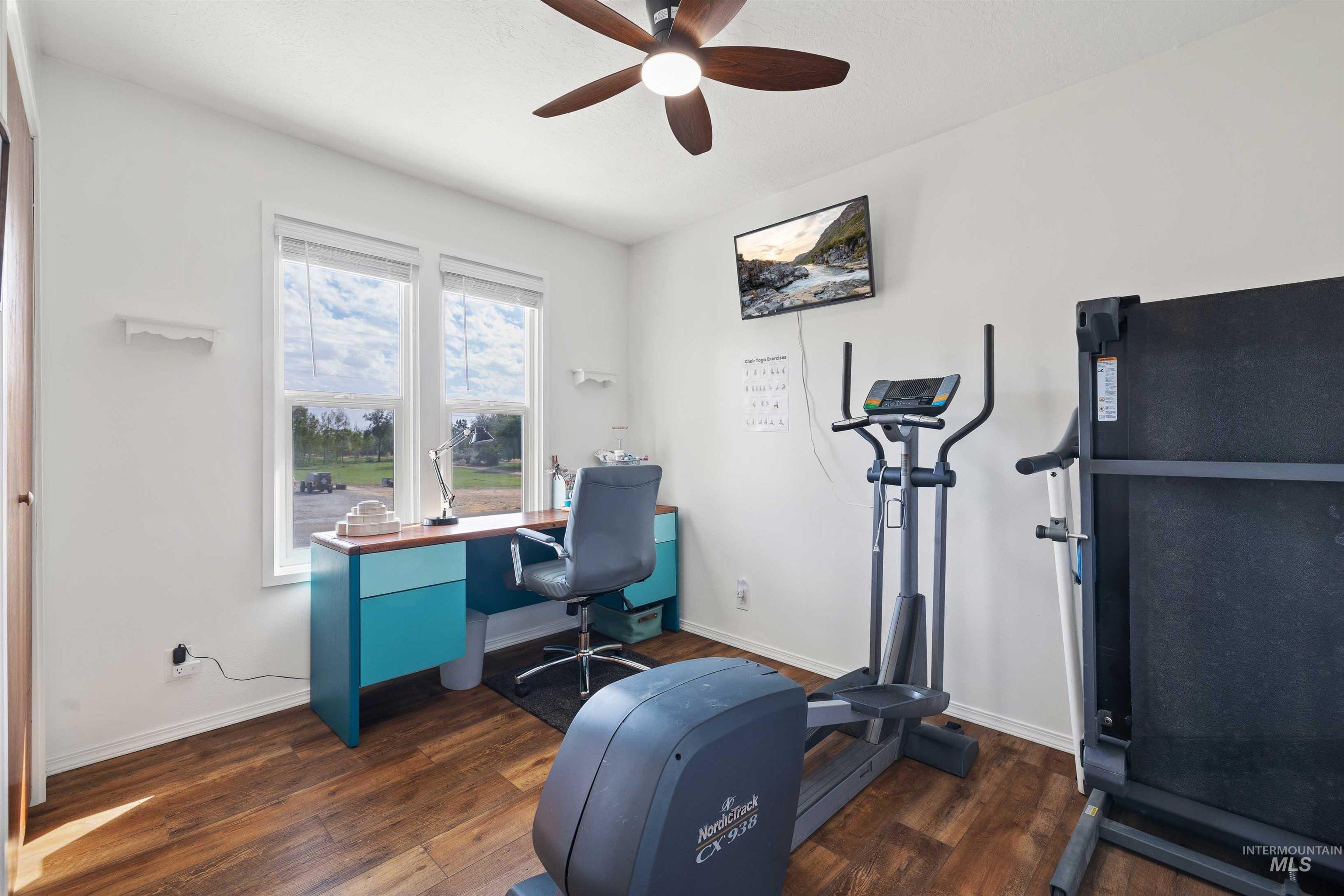 216 Ranch View Road West Jerome, ID 83338 - Photo 23 of 42 Wood-finish flooring, dual windows with blinds, ceiling fan with integrated lighting, wall-mounted display
