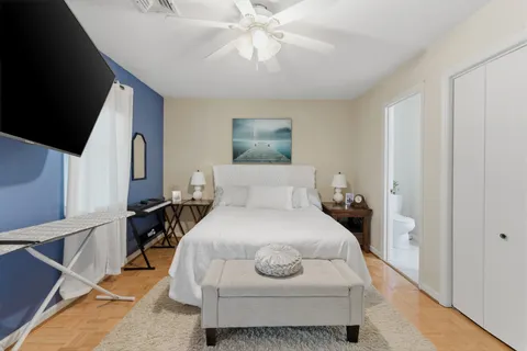 a bedroom with a bed and a chandelier
