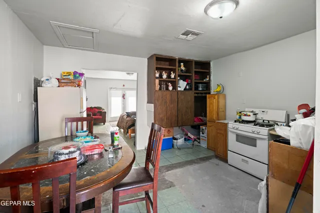 a living room with furniture and a dining table
