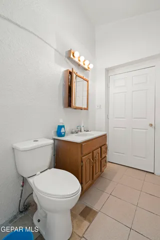 a bathroom with a sink a toilet and mirror