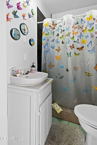 a view of a house with a tree next to a yard