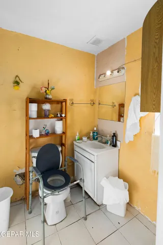 a bathroom with a toilet a sink and a mirror