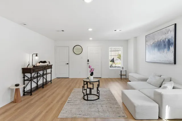 a living room with furniture and wooden floor