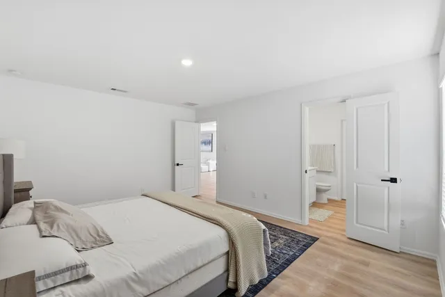 a bedroom with a bed and dresser