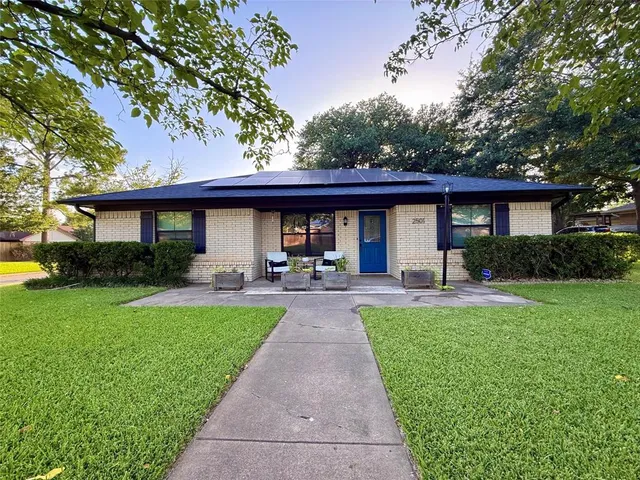 a front view of a house with yard patio and green space