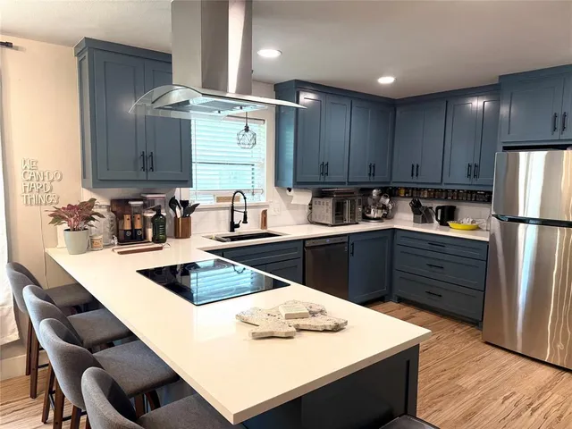a kitchen with granite countertop a sink stove and refrigerator
