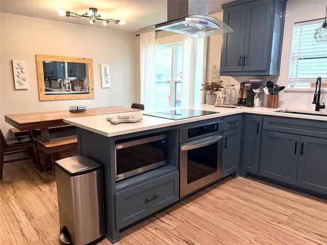 a kitchen with a stove oven and sink