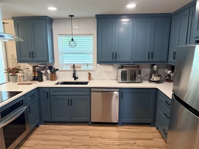 a kitchen with a sink cabinets and window