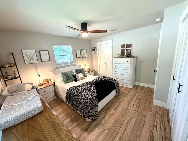 a bedroom with a bed and wooden floor