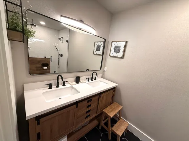 a bathroom with a sink mirror and a toilet