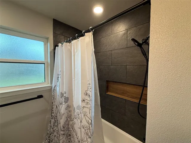 a bathroom with a shower and a sink