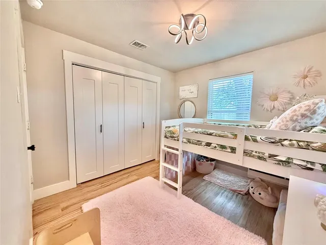 a view of a bedroom with a bed and a window