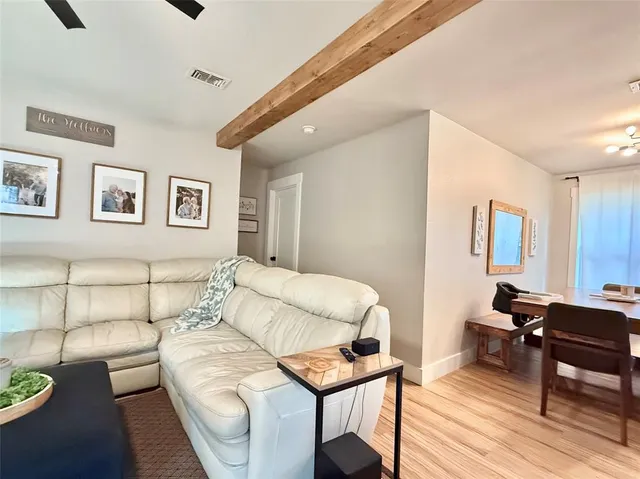 a bedroom with furniture and a wooden floor