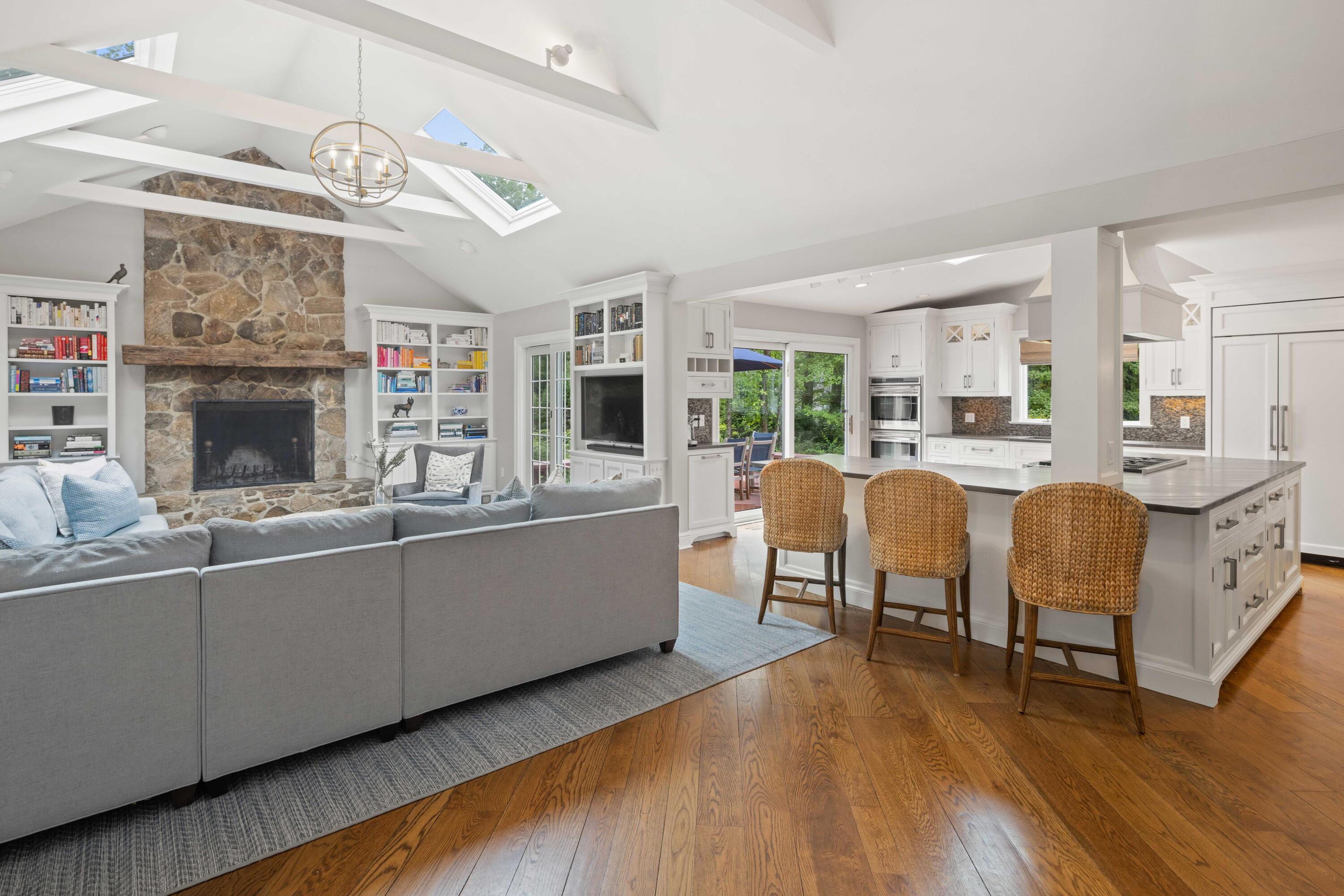 20 Maywood Road Darien, CT 06820 - Photo 9 of 27 a large living room with stainless steel appliances kitchen island granite countertop furniture a fireplace and a large window