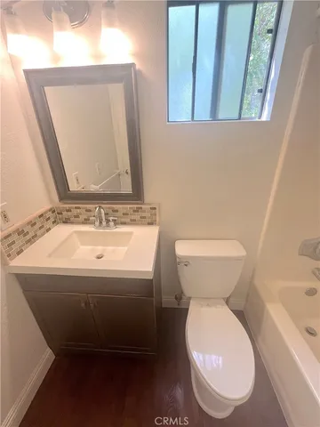 a bathroom with a toilet and a bathtub