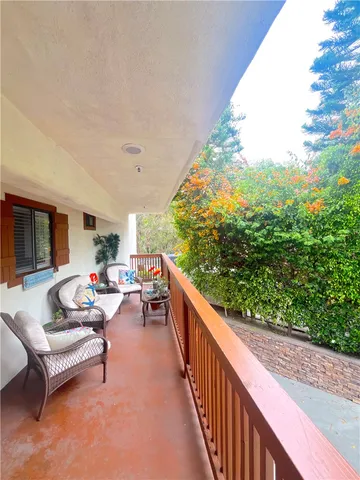 a view of a patio with a table and chairs under an umbrella